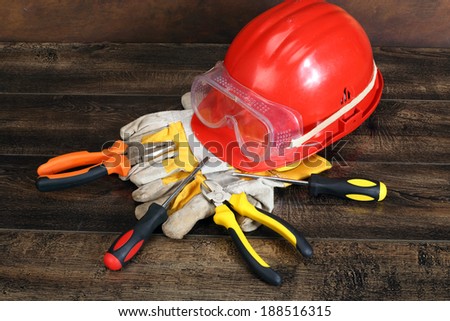 Close up of bunch of hand tools and helmet