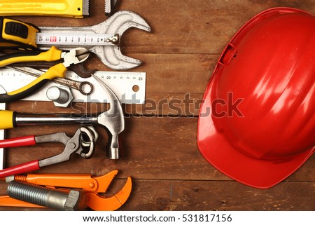 Hand tools and helmet on a workbench