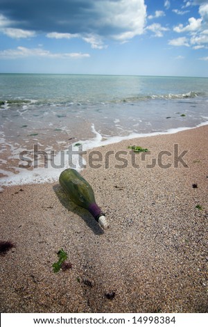 Message in the bottle on lonely beach