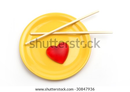 Heart in yellow plate and Chinese sticks