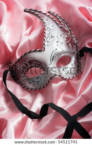 Carnival mask over pink satin