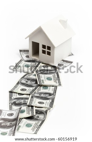 Model of house on the path of money. Real estate concept
