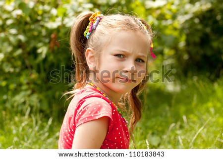 Little girl in a red blouse for someone offended