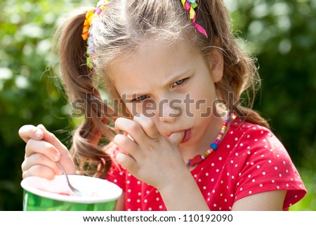 Girl with an appetite for eating delicious ice cream