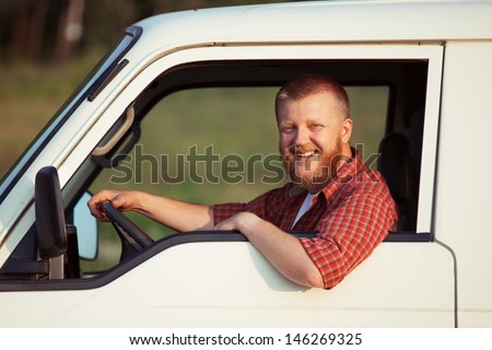 Smiling driver behind the wheel of his car