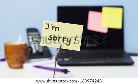 I am sorry written on a memo in a office