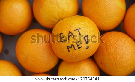 Eat me written on a orange