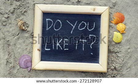Do you like it? written on a chalkboard at the sandy beach
