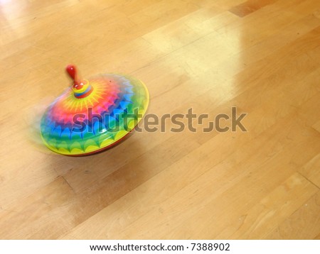 A spinning top on a wood floor