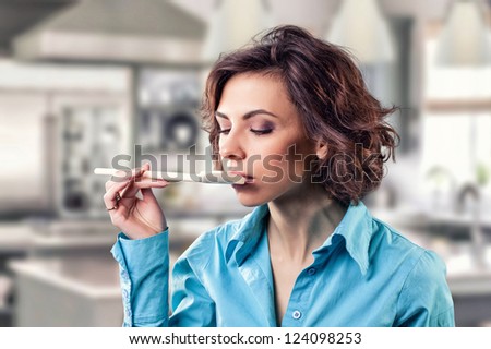 Photo of the girl with a spoon near a mouth