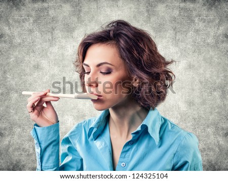 Photo of the girl with a spoon near a mouth