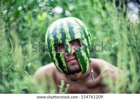 Photo of the young soldier with a water-melon on a head