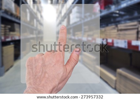 Storage  warehouse management or inventory control. Finger pointing on transparent display