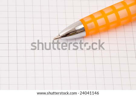 closeup of pen on blank paper ruled with squares