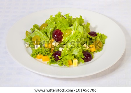 Salad from leaves of green salad, cheese and fruit