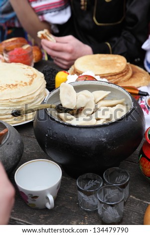Pleasant tea drinking with fragrant fresh beautiful pancakes and fritters and appetizing products from the boiled test with a stuffing from cottage cheese