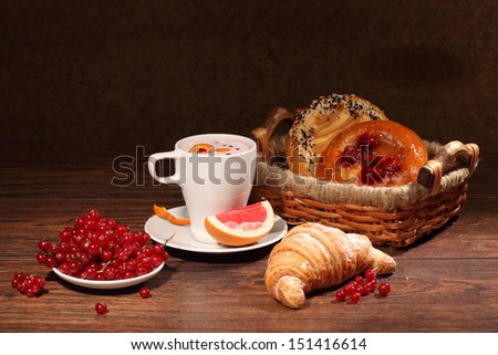 Fragrant fresh tea with juicy grapefruit and whipped cream, a ripe bright red currant both an appetizing cheese cake and a puff pie