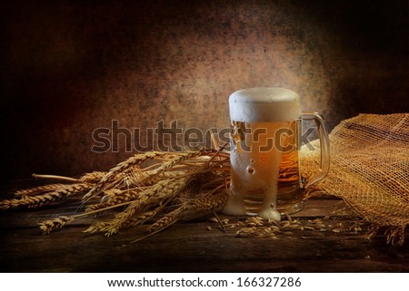 Fresh fragrant foamy beer of light grades in a transparent glass beer mug