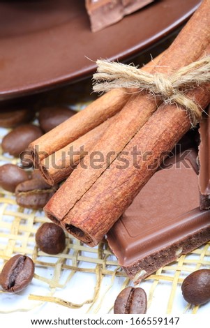 Appetizing chocolate with a nut fragrant sticks of cinnamon and the whole grains of black coffee
