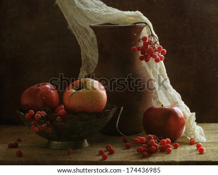 Still-life with apples and berries of a ripe guelder-rose, a clay jug and a copper bowl with apples and clusters of a juicy guelder-rose