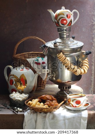 Still-life with fragrant fresh tea both appetizing cookies and the big samovar