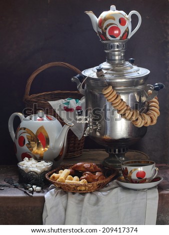 Still-life with fragrant fresh tea both appetizing cookies and the big samovar