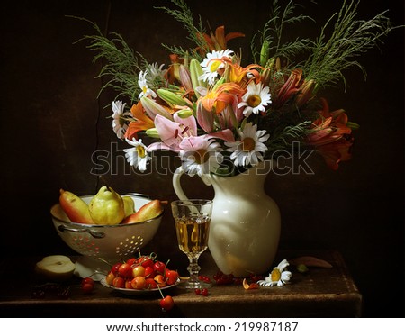 Still-life, appetizing juicy ripe pears both sweet sweet cherry and beautiful bright bouquet from pink and orange lilies and gentle camomiles in a white jug