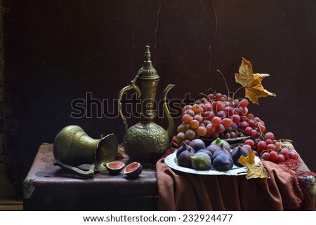 Still-life in east style with a beautiful jug both a ripe fig and juicy grapes