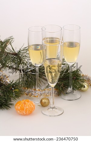 Still-life with wine glasses with a sparkling both fresh tangerine and gold spheres, a New Year\'s still-life