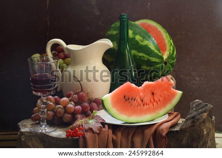 Still-life with wine, a water-melon, grapes, a guelder-rose and a white jug
