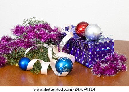 Tinsel, spheres for an ornament of a fur-tree and a gift package, a New Year\'s still-life