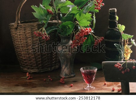 Still-life with fruit liqueur from a guelder-rose and a bouquet in a beautiful vase