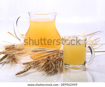 Grain drink - kvass (kvas) in a transparent jug on a white background