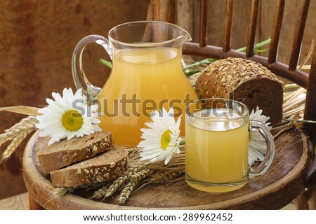 Kvass (Kvas) in a transparent mug, a jug and rye bread