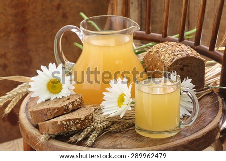 Grain drink - kvass (kvas) in a transparent jug and rye bread