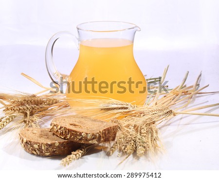 Grain drink - kvass (kvas) in a transparent jug on a white background
