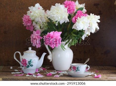 Tea and peonies, bouquet of peonies and fragrant tea in beautiful service