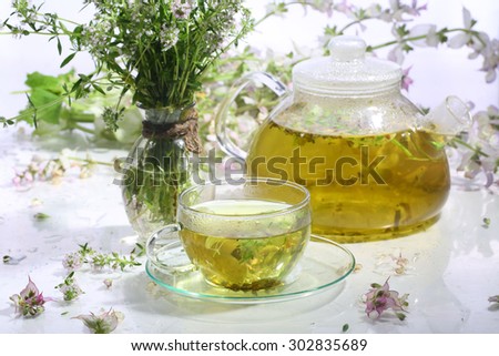 Medical tea from grasses in a transparent cup on a white background