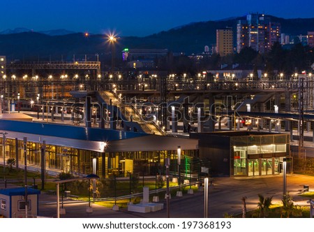 Night city Adler on the Black sea In the foreground train station , next town , on the background of the snow-capped Caucasian mountains