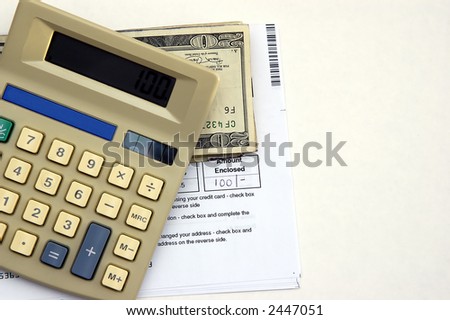 A Calculator, check book and a bill against a white background symbolizing paying bills