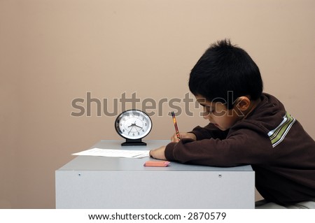 A child diligently taking a test on time