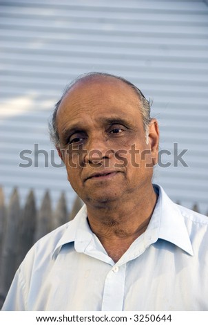 An old indian man smiling in the summer sun