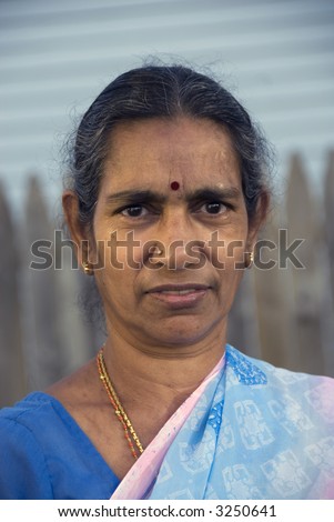An old indian woman smiling in the summer sun
