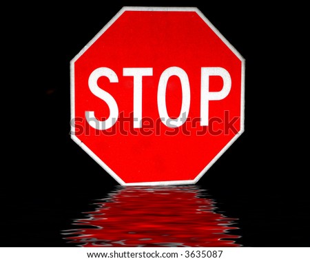 Stop Sign Isolated On Black Background With Reflection Stock Photo