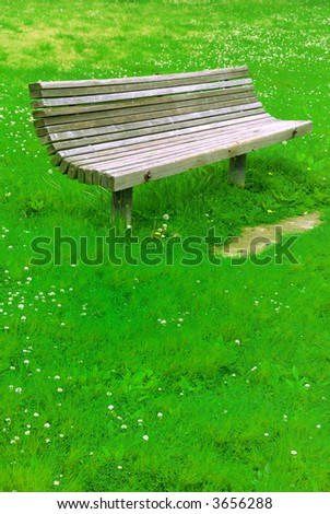 an old park bench isolated on grass back ground