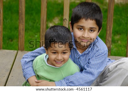 Two Indian brothers happily hugging each other