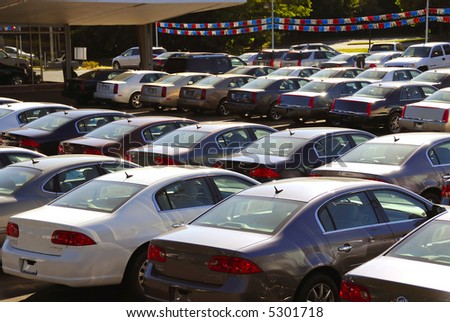 A row of new cars parked at a car dealer shop
