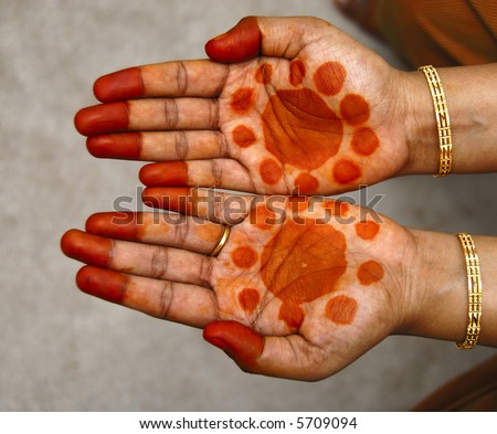 a design on hands against a natural back ground