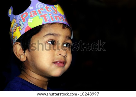 An handsome indian kid having fun at a birthday party