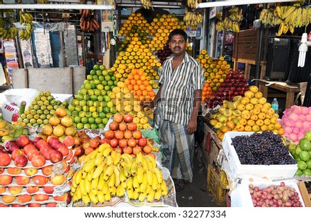 CHENNAI, INDIA - CIRCA MAY 2009 : A fruit vendor sells all sorts of exotic tropical fruits circa May 2009 in Chennai, India.